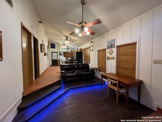 living room with ceiling fan and lofted ceiling