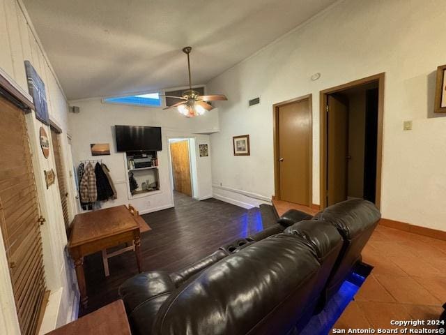 living room with ceiling fan and vaulted ceiling