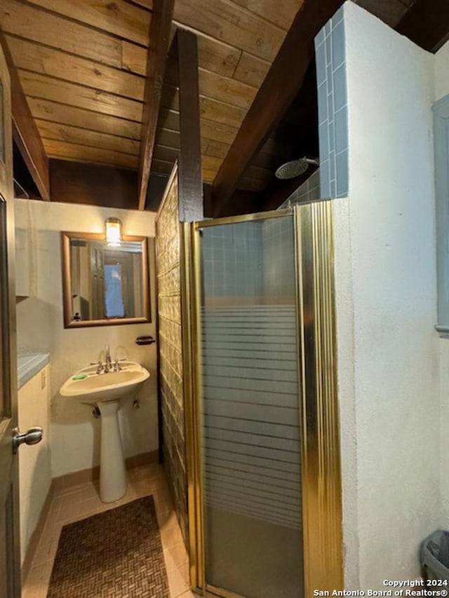 bathroom with beam ceiling, an enclosed shower, and wooden ceiling