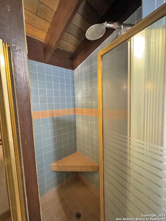 bathroom featuring beamed ceiling, a shower, and wooden ceiling