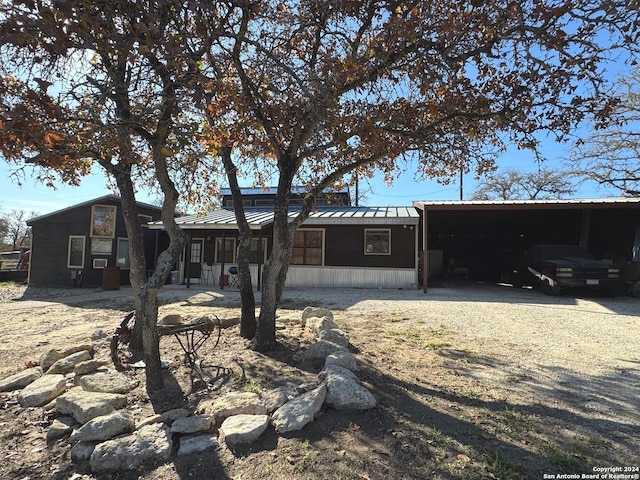 back of property with a carport