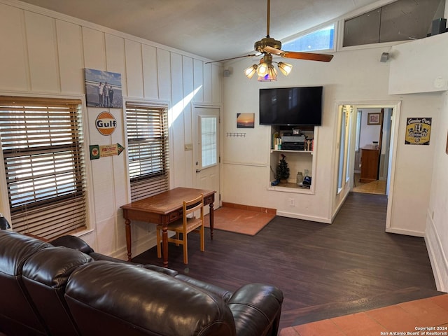 living room with ceiling fan, lofted ceiling, and dark wood-type flooring