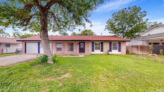 ranch-style home with a garage and a front lawn