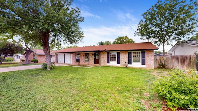 ranch-style home with a garage and a front yard