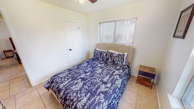 bedroom featuring ceiling fan and light tile patterned flooring