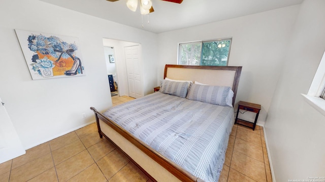 tiled bedroom with ceiling fan