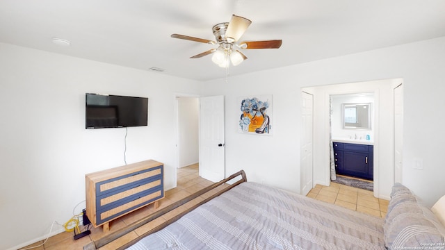 tiled bedroom featuring ensuite bathroom, ceiling fan, and sink