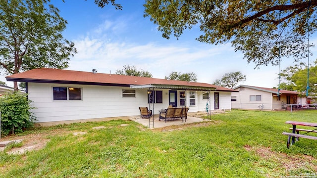 rear view of property featuring a patio area and a yard