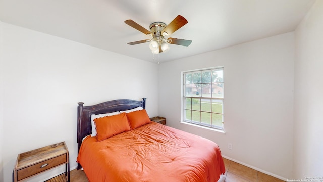 bedroom with ceiling fan and light tile patterned flooring