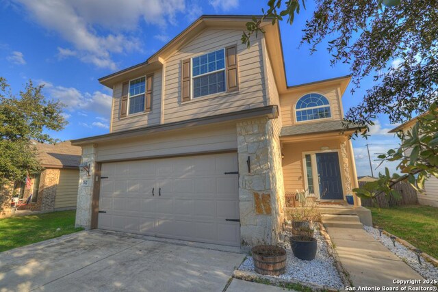 traditional-style house featuring stone siding, an attached garage, and driveway