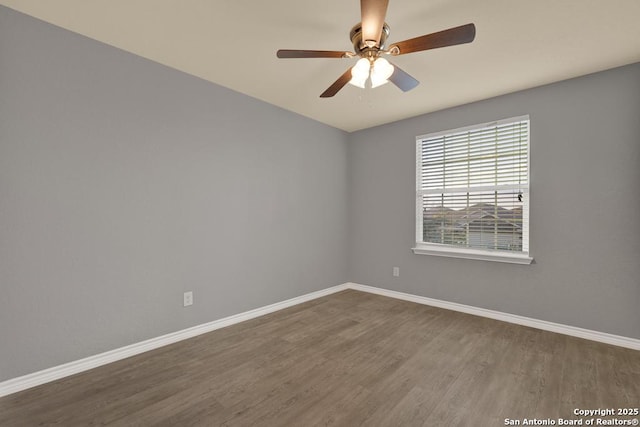 spare room with ceiling fan, baseboards, and wood finished floors