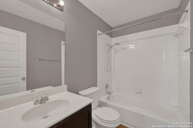 bathroom featuring vanity, toilet, and bathing tub / shower combination