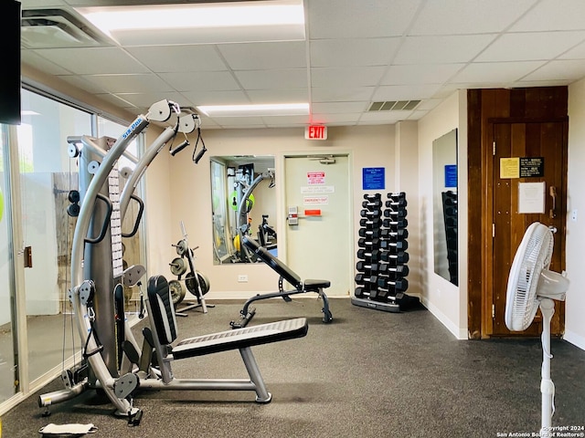 gym with a paneled ceiling