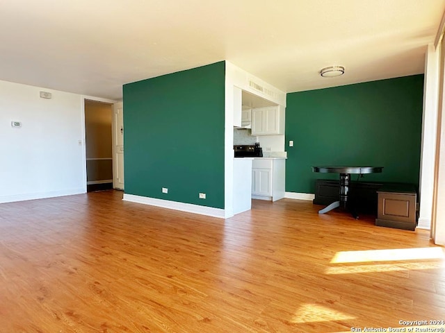 unfurnished living room with light hardwood / wood-style flooring