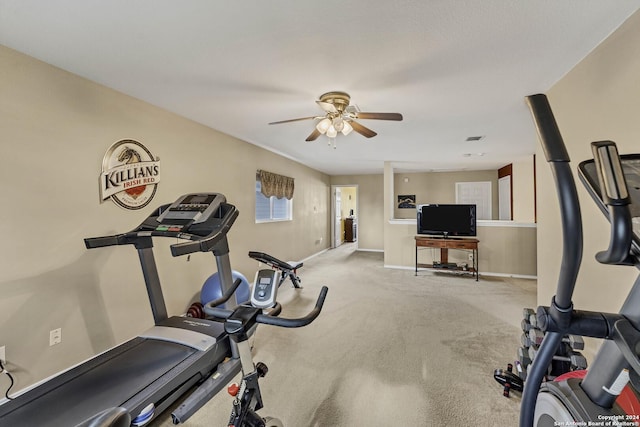 exercise area with light colored carpet and ceiling fan