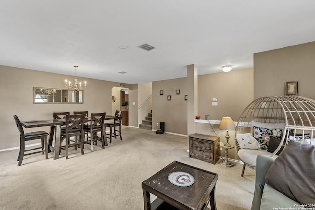 living room featuring light carpet and a chandelier