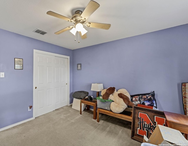 bedroom with carpet, ceiling fan, and a closet