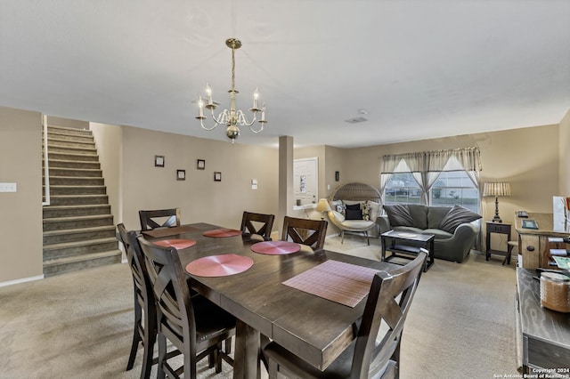 dining space featuring light carpet and a notable chandelier