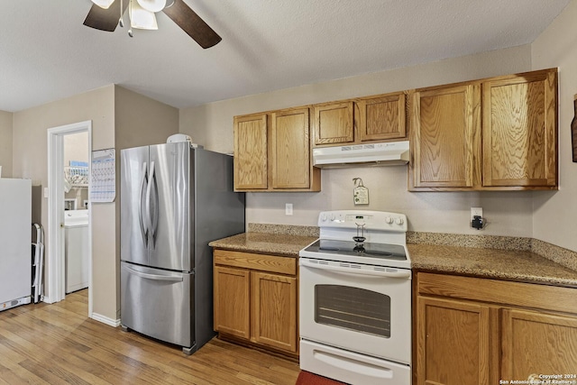 kitchen with white appliances, a textured ceiling, ceiling fan, light hardwood / wood-style flooring, and washer / dryer