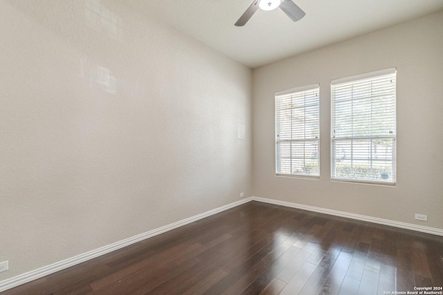 spare room featuring dark hardwood / wood-style floors and ceiling fan