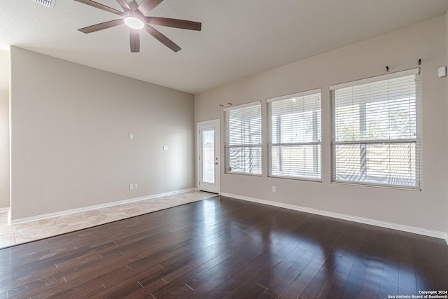 spare room featuring ceiling fan, plenty of natural light, and wood-type flooring