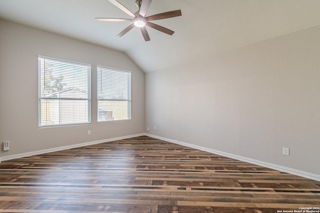 empty room featuring ceiling fan, dark hardwood / wood-style flooring, and vaulted ceiling