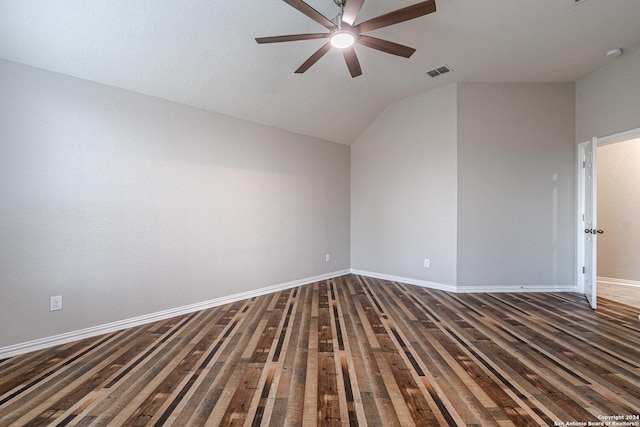 spare room featuring ceiling fan, dark hardwood / wood-style flooring, and vaulted ceiling