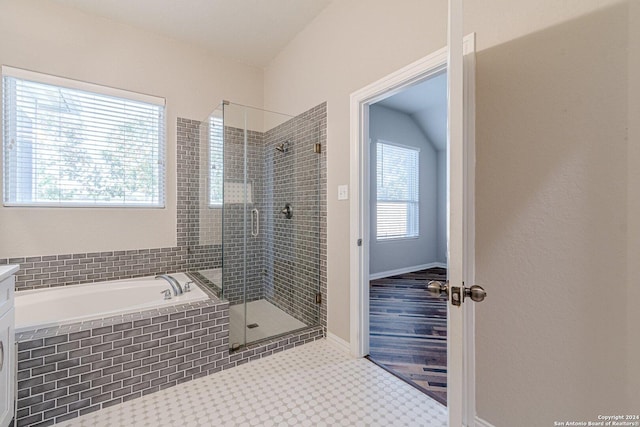 bathroom featuring vanity and independent shower and bath