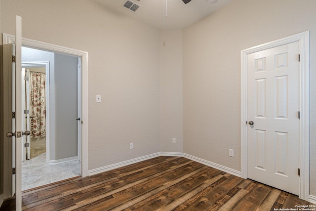 spare room with ceiling fan and dark wood-type flooring