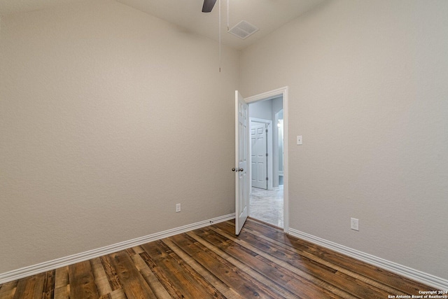 empty room with ceiling fan and dark hardwood / wood-style flooring