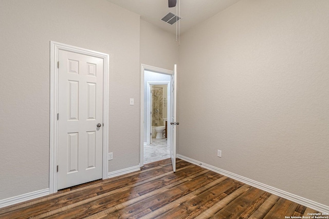 unfurnished bedroom with ceiling fan and dark hardwood / wood-style floors