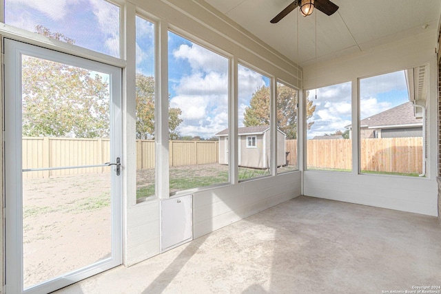 unfurnished sunroom with ceiling fan