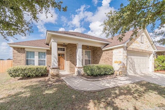 view of front of property featuring covered porch and a garage