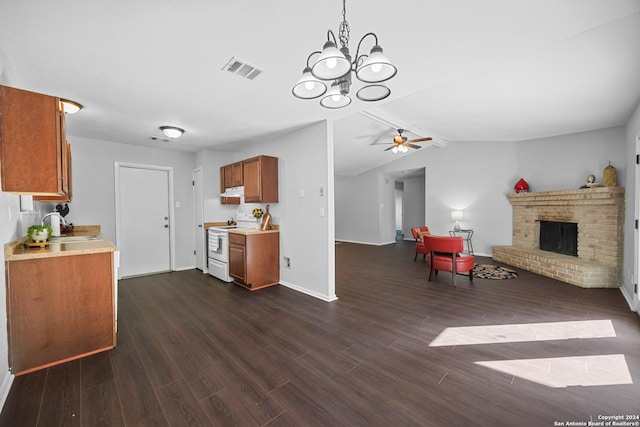 kitchen featuring ceiling fan with notable chandelier, vaulted ceiling, dark hardwood / wood-style floors, a fireplace, and white range with electric stovetop