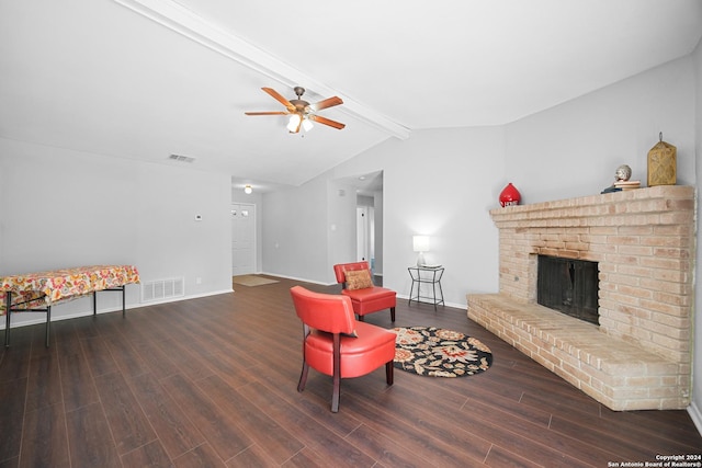 living room featuring vaulted ceiling with beams, ceiling fan, dark hardwood / wood-style flooring, and a brick fireplace