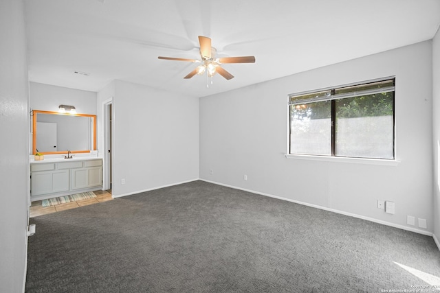 unfurnished bedroom featuring carpet, ceiling fan, and connected bathroom