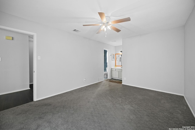 carpeted spare room with ceiling fan