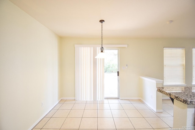 unfurnished dining area featuring light tile patterned flooring