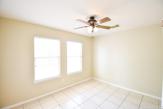 spare room featuring ceiling fan and light tile patterned floors