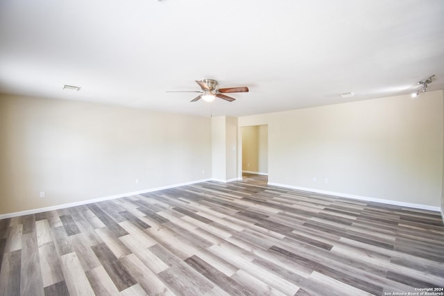 empty room with ceiling fan and light wood-type flooring