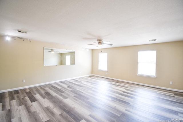 unfurnished room with hardwood / wood-style floors and a textured ceiling