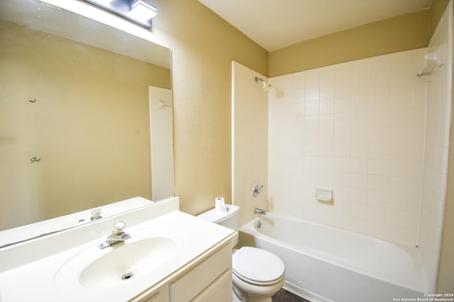 full bathroom featuring vanity, tiled shower / bath combo, and toilet