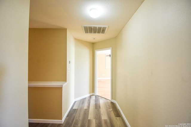 hallway with hardwood / wood-style flooring