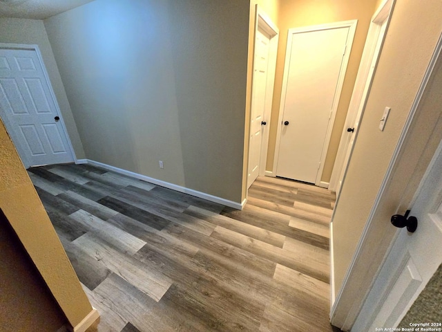 corridor with light hardwood / wood-style floors