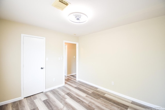 unfurnished room with light wood-type flooring