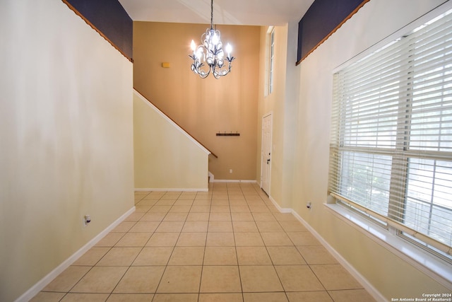 tiled entrance foyer with a chandelier