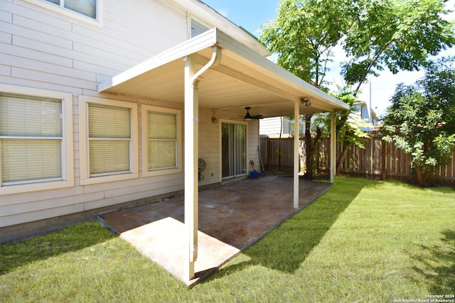 view of yard featuring a patio area and ceiling fan