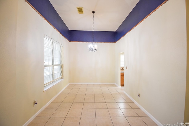 unfurnished dining area with tile patterned flooring and an inviting chandelier