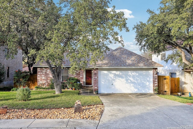 ranch-style home with a garage and a front lawn