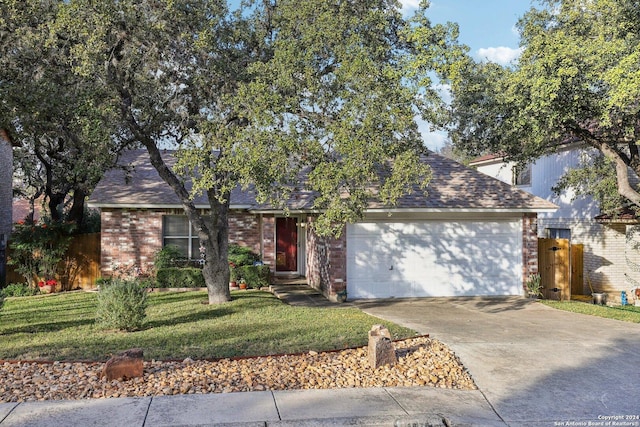 view of front of property with a front yard and a garage